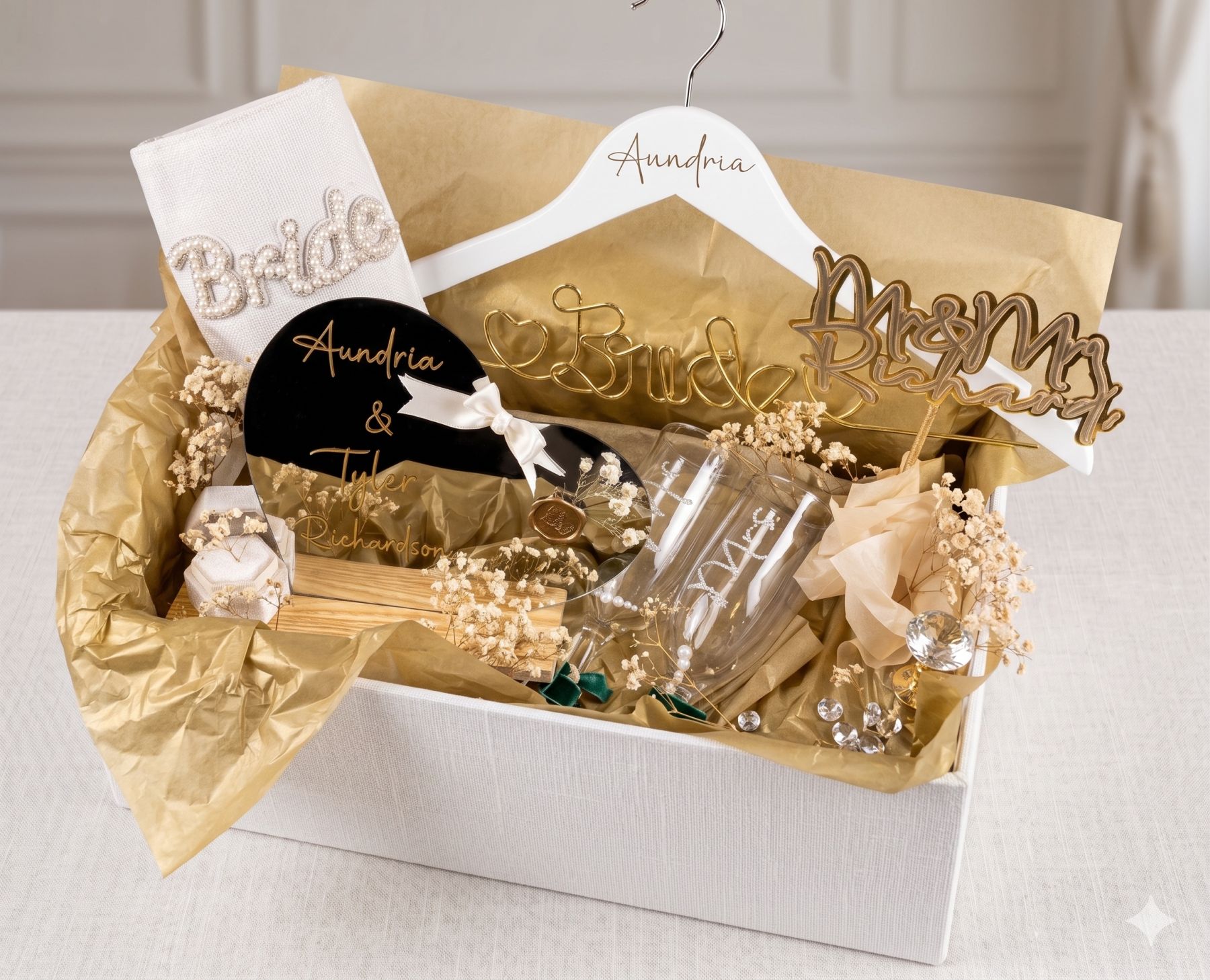 Custom Aundria and Tyler Richardson wedding gift set with Bride bag, hanger, Mr & Mrs cake topper, Mrs flutes, and dried florals